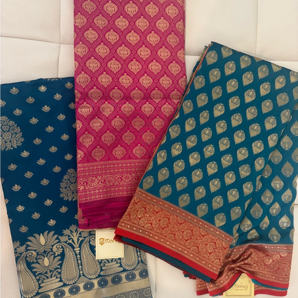 Brand new sarees with tags intact.Elegant Pink and Blue Sarees with Gold Accents
